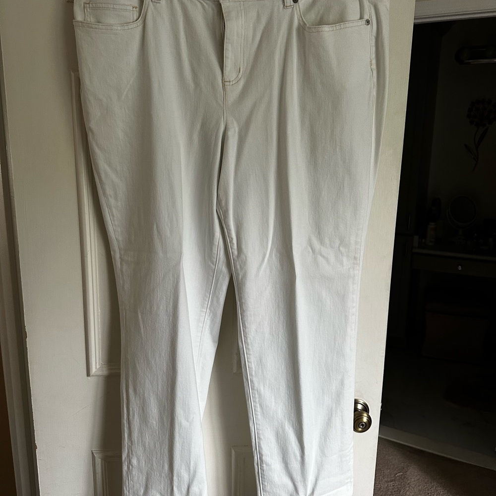 Chalk white stretch jeans with orange stitching.